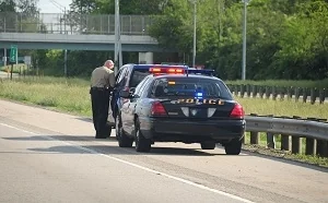 A police man writing a speeding ticket in Atlanta, GA who needs an Atlanta traffic ticket lawyer