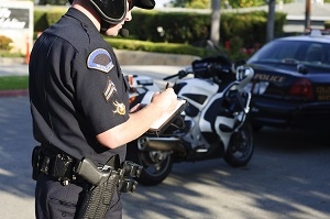 A cop writing a traffic ticket for motorcyclist in Atlanta, GA.